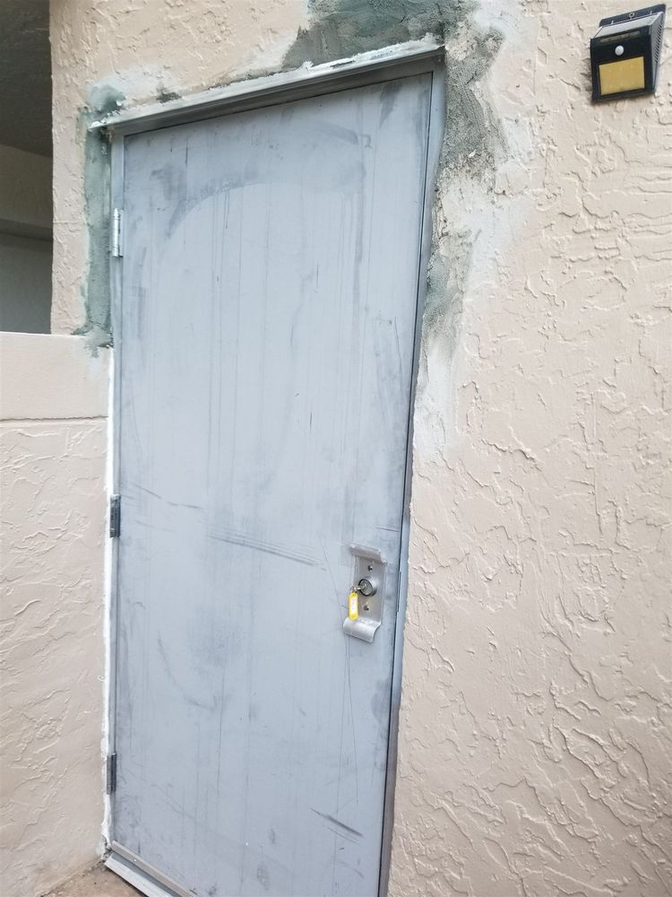 New steel frame set in an exterior wall with patching still unfinished