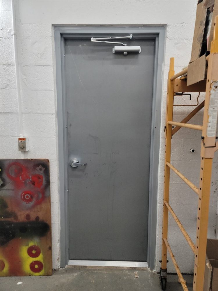 Steel service door finished with new closer and painted frame
