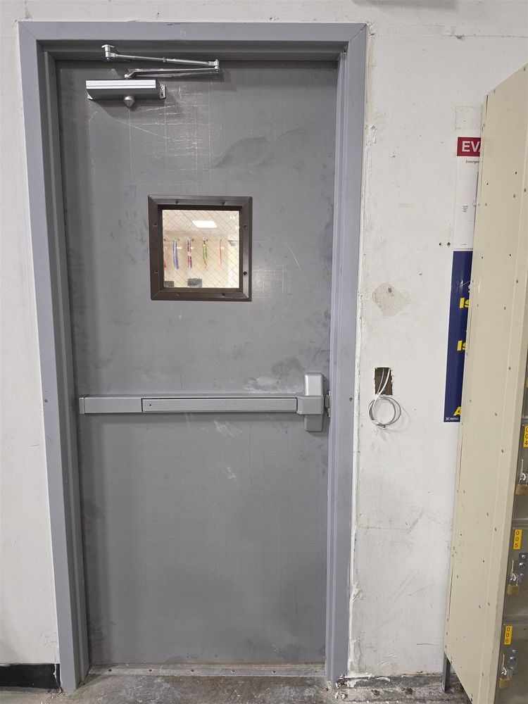 Steel corridor door with vision lite, panic bar and closer