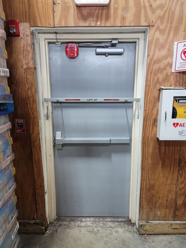 Steel door with wire-glass vision lite and panic bar