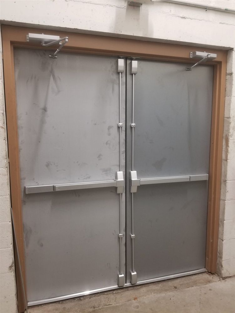 Pair of steel doors with vertical rod panic hardware