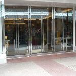 Herculite all-glass storefront doors with pivots and floor closers