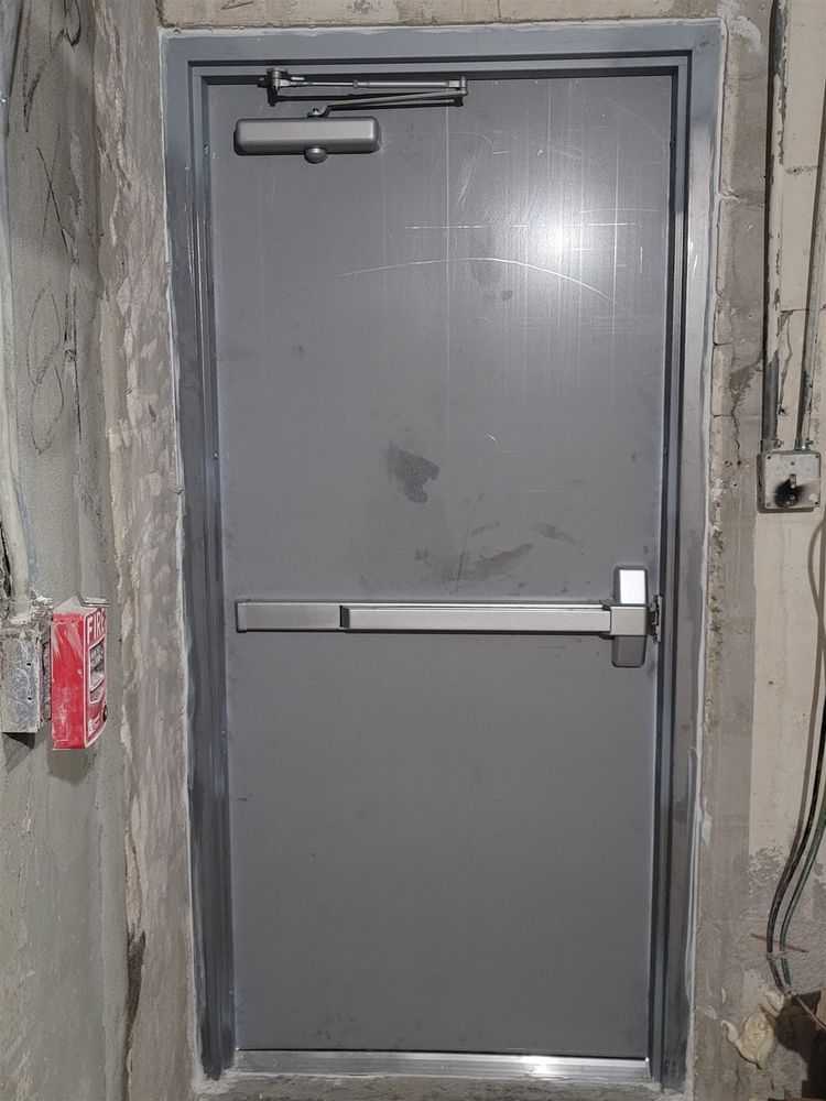 Hollow metal door with panic bar and closer in a back corridor