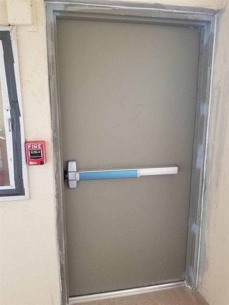 Steel door with a rim exit device (panic bar)