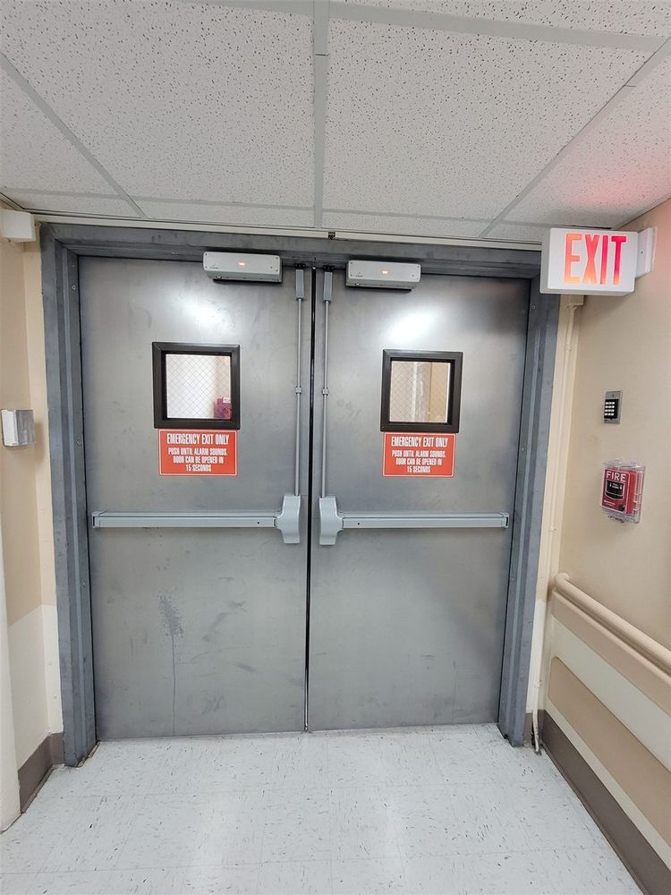 Pair of steel doors with exit devices and vision lites
