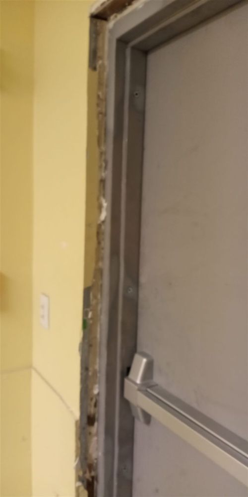 Exit device bar on a steel door in a new frame