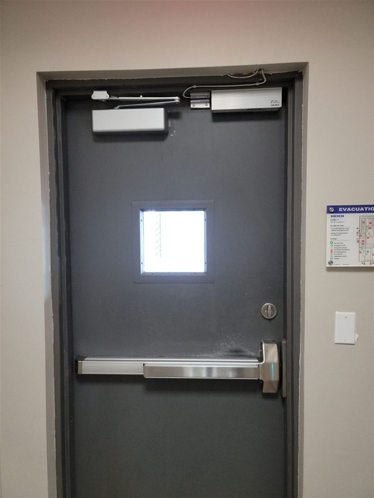 Steel door with exit device and overhead closer