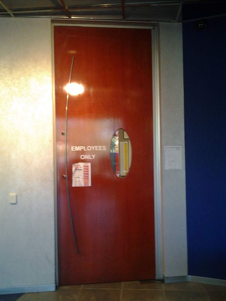 Wood employees-only door with a full-height continuous hinge