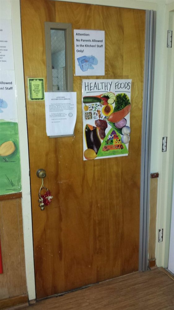 Wood kitchen door with a continuous hinge installed over old butt-hinge cutouts