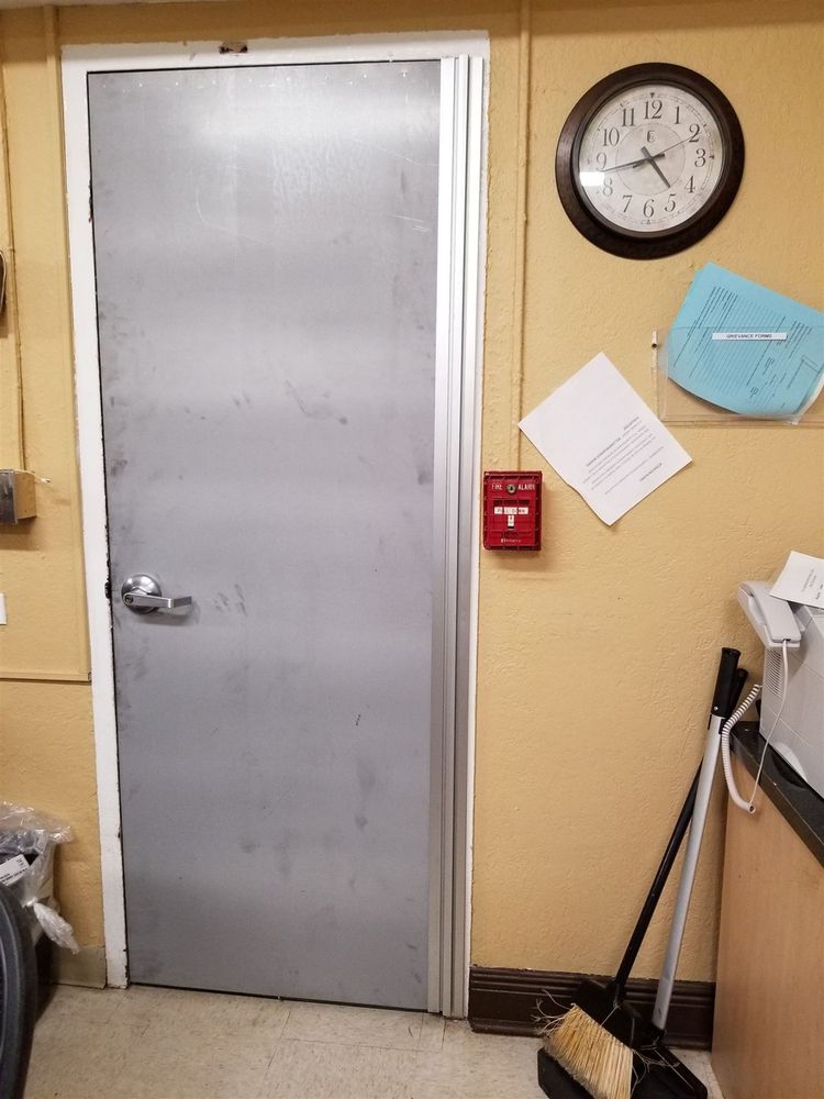 Gray hollow metal interior door with a full-height continuous hinge