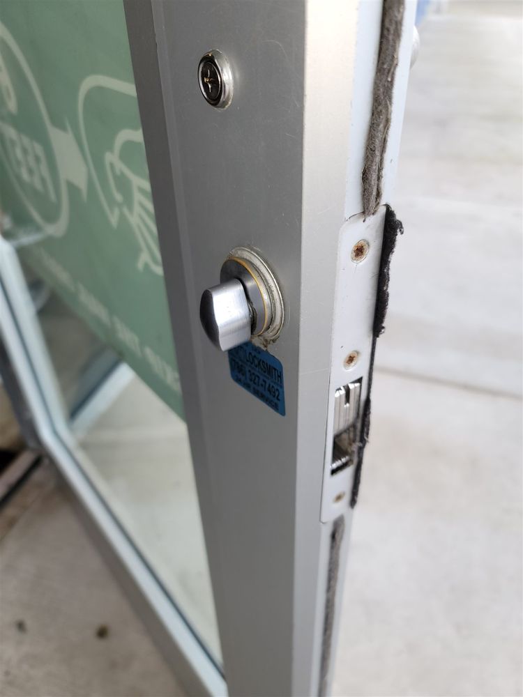 Lock and cylinder on the edge of an aluminum storefront door