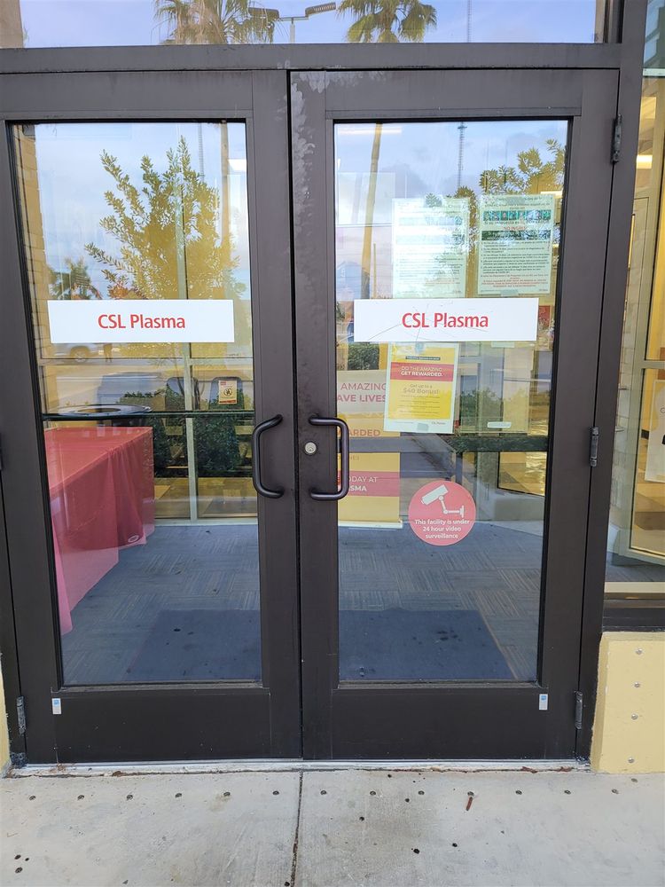 Pair of dark bronze aluminum storefront doors at a retail entrance
