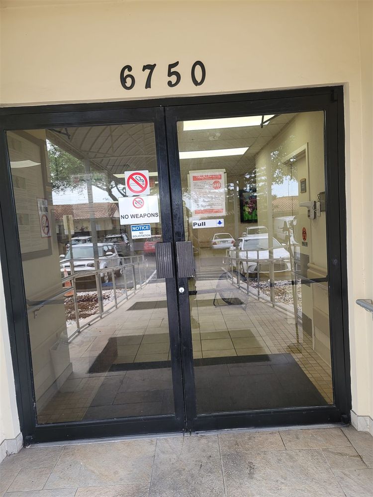 Dark aluminum storefront double doors at a commercial entry