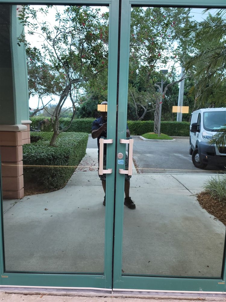 Green-framed aluminum and glass storefront doors