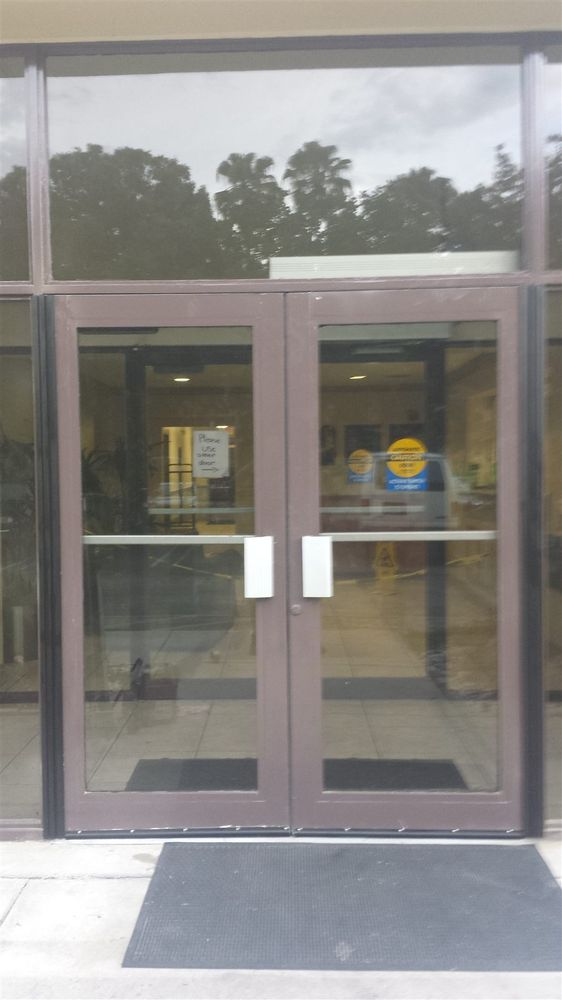 Bronze aluminum storefront doors at a plaza entrance
