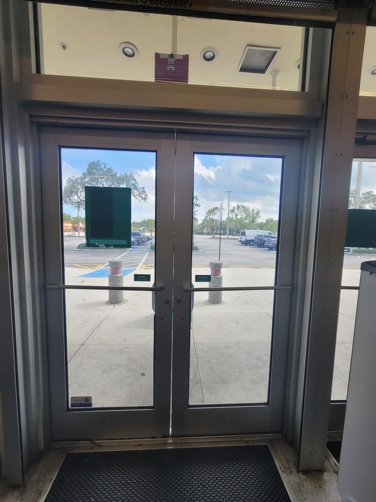Dark aluminum storefront doors with pull handles