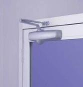 Surface door closer on an aluminum commercial door